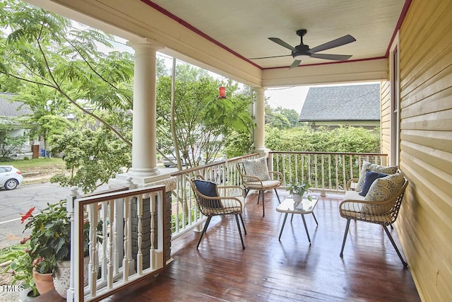 wooden deck with covered porch and ceiling fan