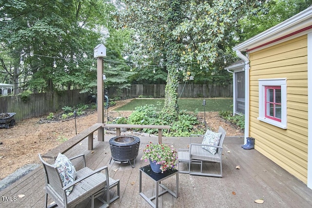 view of patio / terrace with a fenced backyard, an outdoor fire pit, and a wooden deck