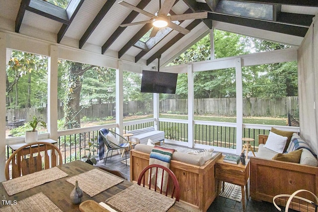 sunroom featuring ceiling fan, an outdoor living space, and a skylight