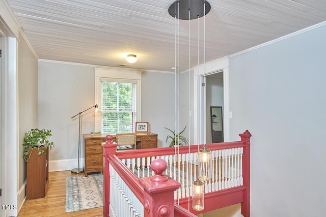 bedroom with ornamental molding, wood finished floors, and baseboards