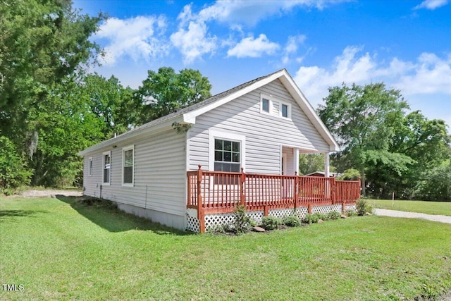 view of home's exterior with a yard and a deck