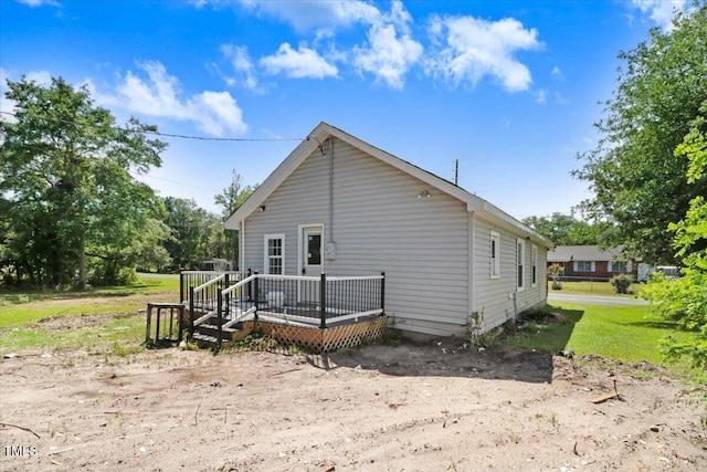 rear view of house featuring a wooden deck