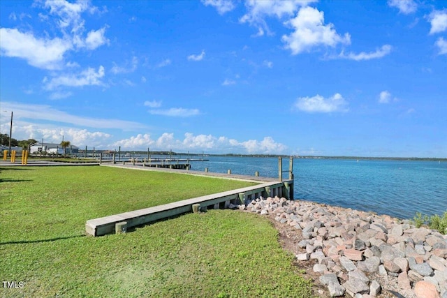 dock area featuring a water view and a yard