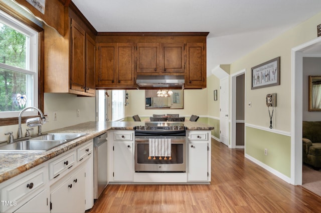 124 Windmere Dr, Angier, NC 27501 - kitchen featuring a sink, appliances with stainless steel finishes, a peninsula, light wood finished floors, and under cabinet range hood