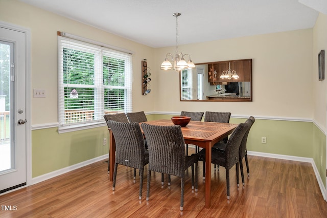 124 Windmere Dr, Angier, NC 27501 - dining area featuring a chandelier, wood finished floors, and baseboards