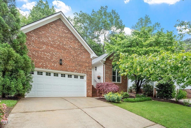 view of front of house with brick siding, driveway, and a front lawn