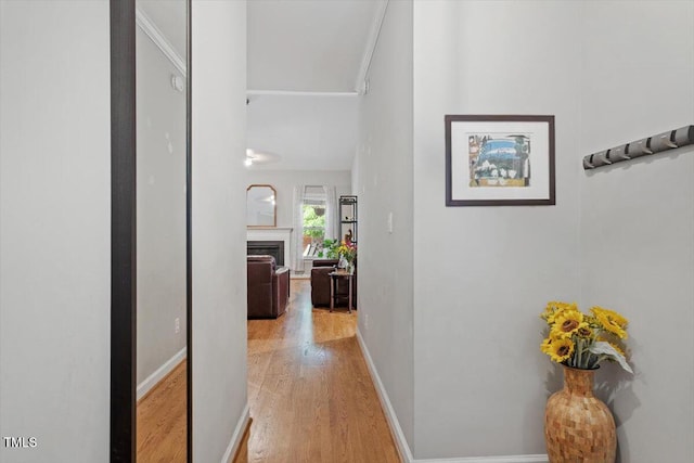 hall with wood finished floors and baseboards