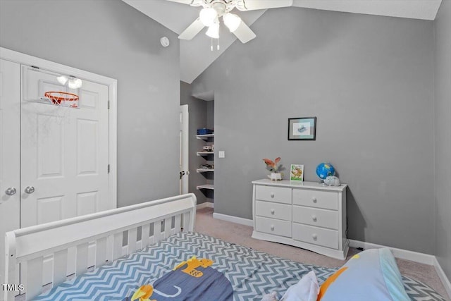 bedroom with baseboards, light colored carpet, high vaulted ceiling, a ceiling fan, and a closet