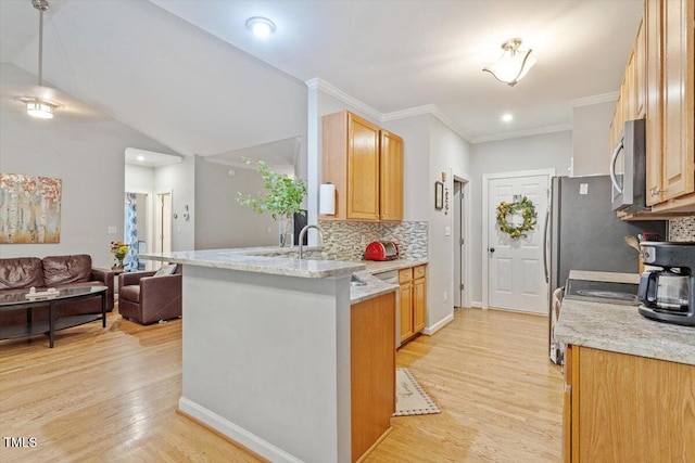 kitchen with stainless steel microwave, light wood-style flooring, a peninsula, decorative backsplash, and open floor plan