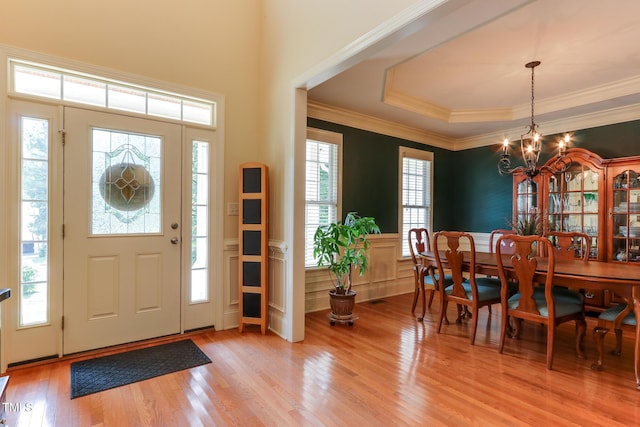 119 Marykirk Pl, Garner, NC 27529 - entrance foyer featuring a chandelier, light wood-style floors, a wainscoted wall, crown molding, and a decorative wall