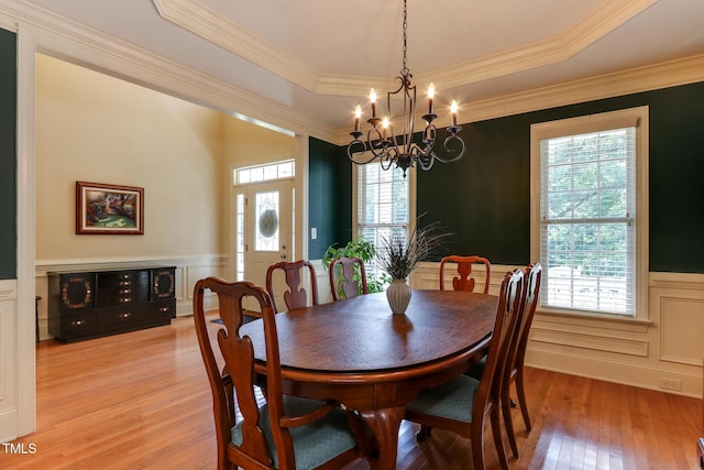 119 Marykirk Pl, Garner, NC 27529 - dining area with light wood-style flooring, wainscoting, a chandelier, plenty of natural light, and a decorative wall