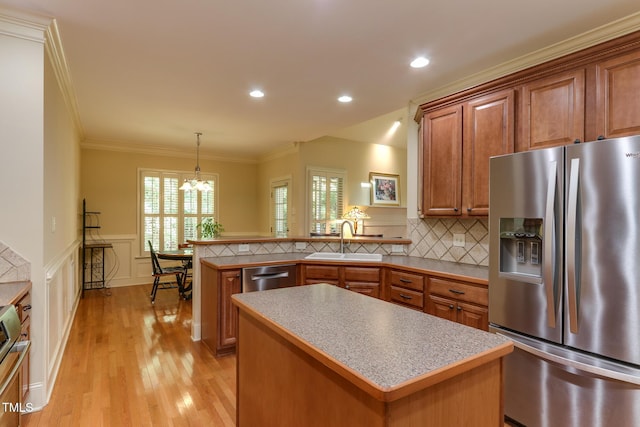 119 Marykirk Pl, Garner, NC 27529 - kitchen with stainless steel appliances, a sink, a chandelier, light wood-type flooring, and brown cabinets