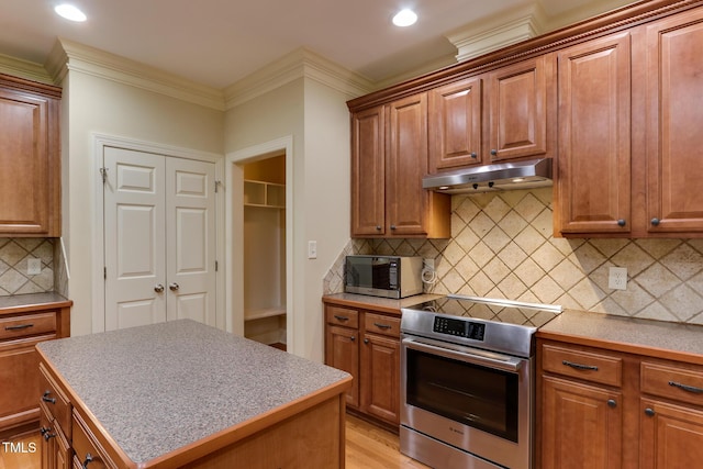 119 Marykirk Pl, Garner, NC 27529 - kitchen with electric range, under cabinet range hood, decorative backsplash, crown molding, and brown cabinets