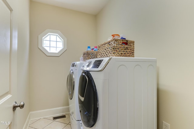 119 Marykirk Pl, Garner, NC 27529 - clothes washing area featuring washer and dryer, light tile patterned flooring, and baseboards