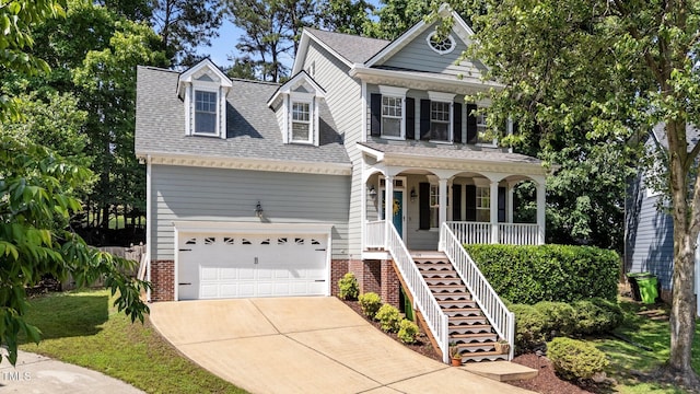 view of front of property featuring covered porch, concrete driveway, brick siding, and a shingled roof