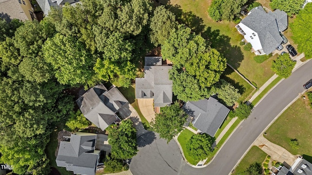 aerial view of property and surrounding area featuring nearby suburban area