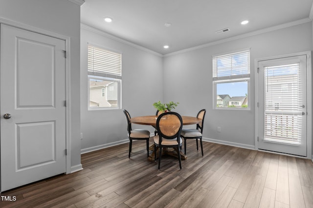 6352 Perry Creek Rd, Raleigh, NC 27616 - dining space featuring dark wood-style flooring, crown molding, baseboards, and recessed lighting