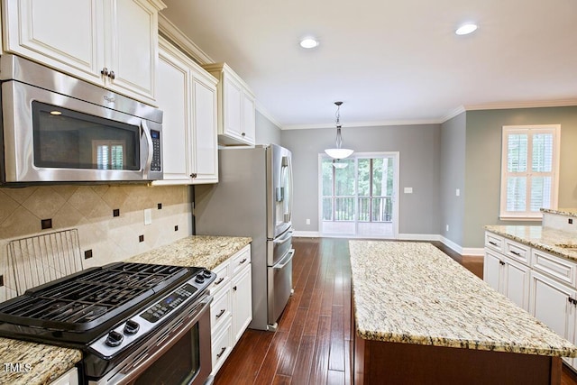 337 Shadowdale Ln, Rolesville, NC 27571 - kitchen with stainless steel appliances, dark wood-style floors, light stone countertops, a center island, and baseboards