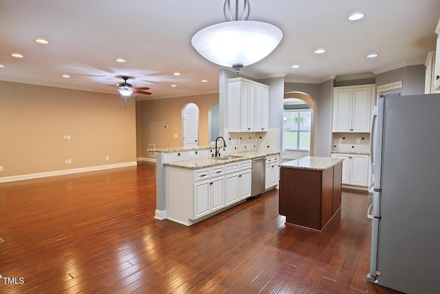 337 Shadowdale Ln, Rolesville, NC 27571 - kitchen featuring appliances with stainless steel finishes, arched walkways, a sink, ceiling fan, and ornamental molding