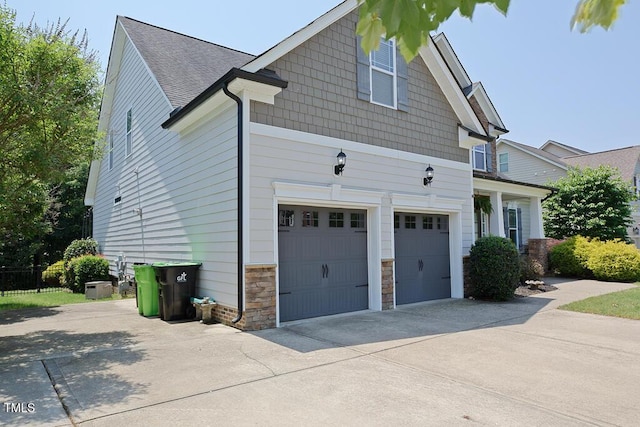 337 Shadowdale Ln, Rolesville, NC 27571 - view of property exterior with an attached garage, driveway, stone siding, and roof with shingles