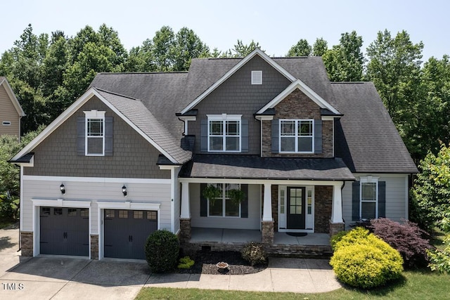 337 Shadowdale Ln, Rolesville, NC 27571 - craftsman-style house featuring stone siding, a porch, an attached garage, and concrete driveway