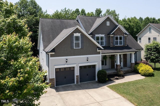 337 Shadowdale Ln, Rolesville, NC 27571 - craftsman-style house with covered porch, stone siding, an attached garage, concrete driveway, and a front lawn