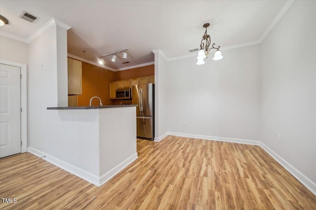1301 Durlain Dr Unit 103, Raleigh, NC 27614 - kitchen featuring stainless steel appliances, track lighting, light wood-type flooring, a chandelier, and crown molding
