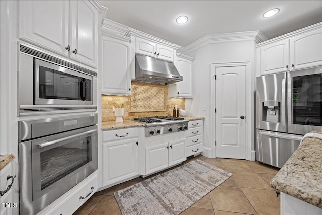 2507 Mayview Rd, Raleigh, NC 27607 - kitchen featuring stainless steel appliances, under cabinet range hood, white cabinetry, ornamental molding, and recessed lighting