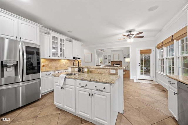 2507 Mayview Rd, Raleigh, NC 27607 - kitchen with appliances with stainless steel finishes, a sink, light tile patterned floors, backsplash, and crown molding