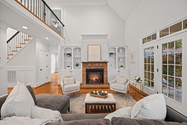 2507 Mayview Rd, Raleigh, NC 27607 - living area featuring high vaulted ceiling, wood finished floors, a fireplace, stairs, and baseboards