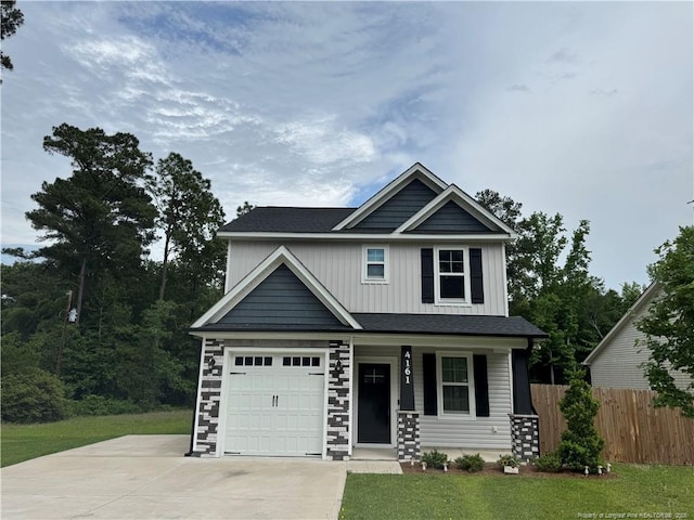 4161 Overhills Rd, Spring Lake, NC 28390 - view of front of home with concrete driveway, a porch, board and batten siding, and a garage