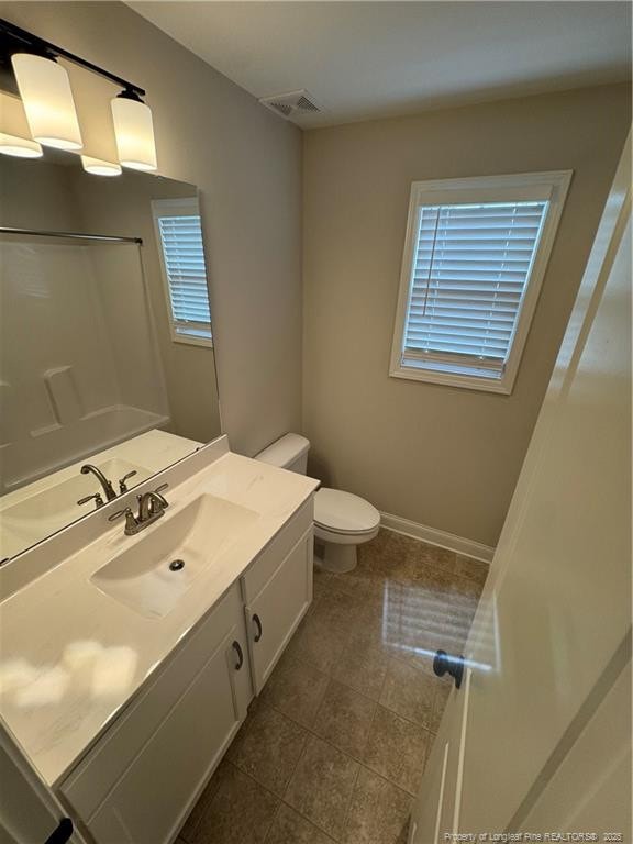 4161 Overhills Rd, Spring Lake, NC 28390 - full bathroom with toilet, vanity, a shower, tile patterned floors, and baseboards