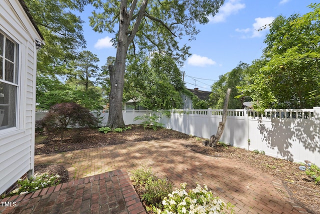 fenced backyard with a patio