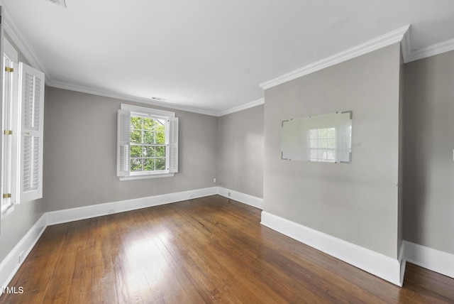 unfurnished room with hardwood / wood-style flooring, baseboards, and crown molding