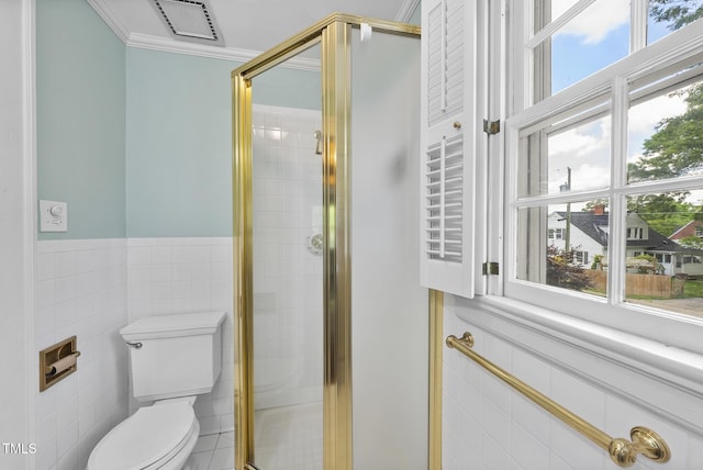 full bathroom featuring tile walls, plenty of natural light, a shower stall, toilet, and ornamental molding