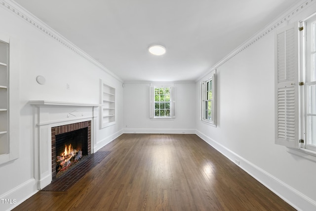 unfurnished living room with built in shelves, baseboards, a fireplace, wood finished floors, and crown molding