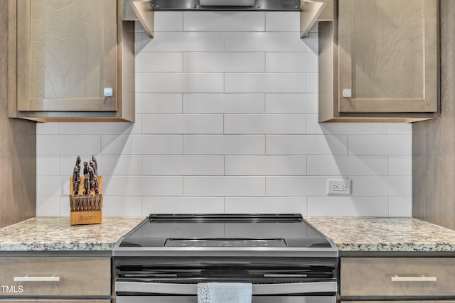 1109 Agio Ct, Zebulon, NC 27597 - kitchen with range with electric cooktop, decorative backsplash, and light stone counters