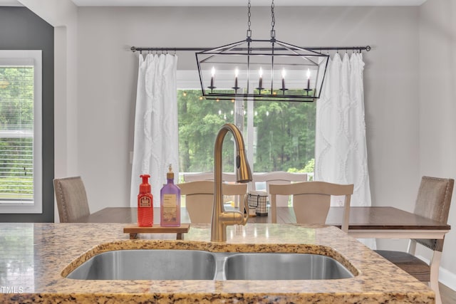 1109 Agio Ct, Zebulon, NC 27597 - dining area view of a sink, a chandelier, and baseboards