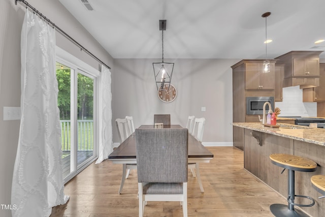 1109 Agio Ct, Zebulon, NC 27597 - dining space featuring light wood finished floors, recessed lighting, and baseboards