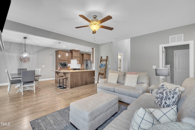 1109 Agio Ct, Zebulon, NC 27597 - living area featuring ceiling fan, light wood finished floors, and baseboards