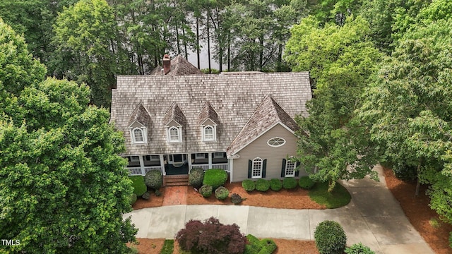 cape cod home with a porch and a chimney