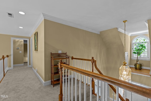 hallway with an upstairs landing, crown molding, carpet floors, baseboards, and recessed lighting