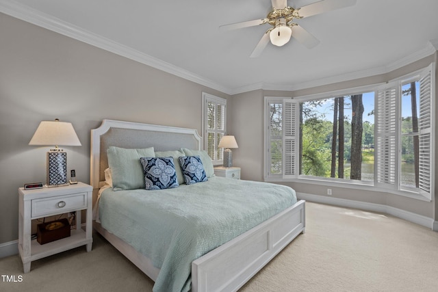 bedroom with baseboards, ornamental molding, light carpet, multiple windows, and ceiling fan