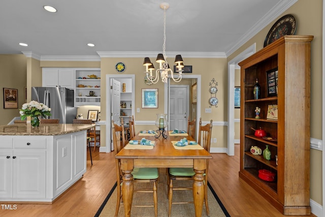 dining space with a chandelier, light wood-type flooring, ornamental molding, and recessed lighting