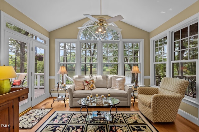 sunroom / solarium with french doors, healthy amount of natural light, vaulted ceiling, and wood finished floors