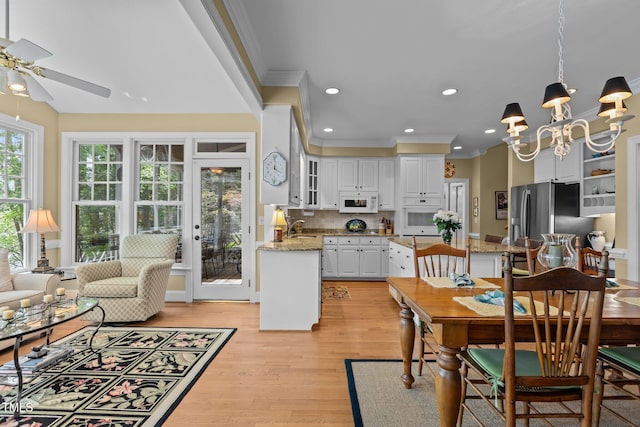 dining area with ceiling fan, ornamental molding, light wood-type flooring, recessed lighting, and a chandelier