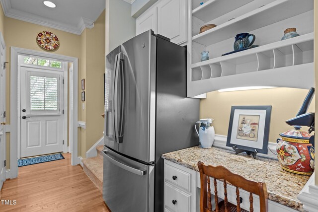 kitchen featuring stainless steel fridge, crown molding, white cabinets, light wood finished floors, and open shelves