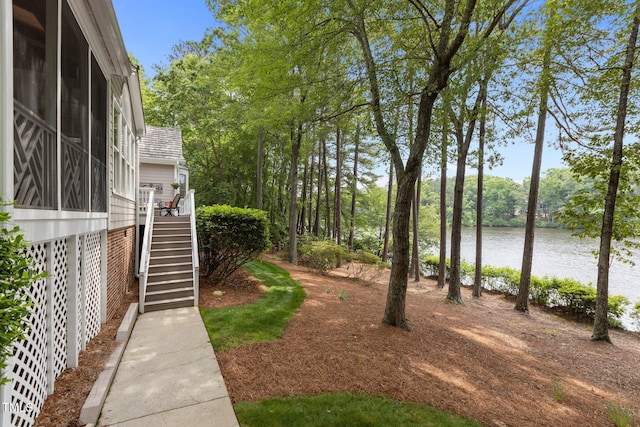view of yard featuring stairway and a water view