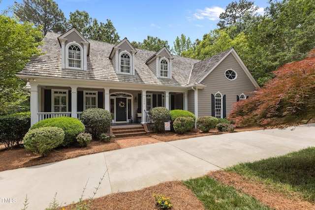 new england style home featuring a porch