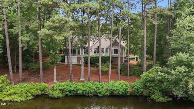 rear view of property with a water view